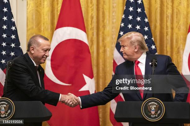 President Donald Trump shakes hands with Recep Tayyip Erdogan, Turkey's president, left, during a joint press conference at the White House in...