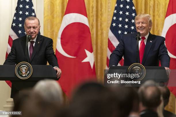 President Donald Trump and Recep Tayyip Erdogan, Turkey's president, left, react during a joint press conference at the White House in Washington,...