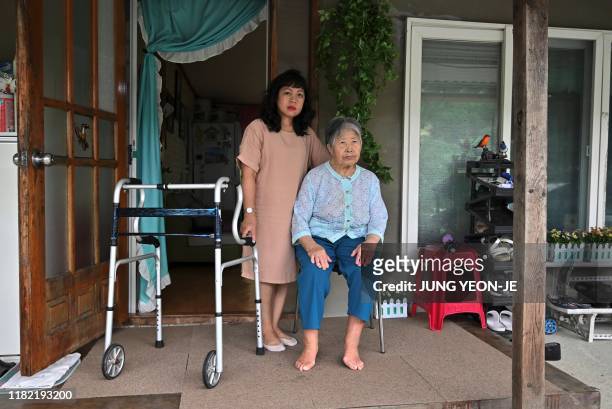 This picture taken on August 30, 2019 shows Emma Sumampong and her mother-in-law Kim Geum-nyeo posing for a photo during an interview with AFP at her...