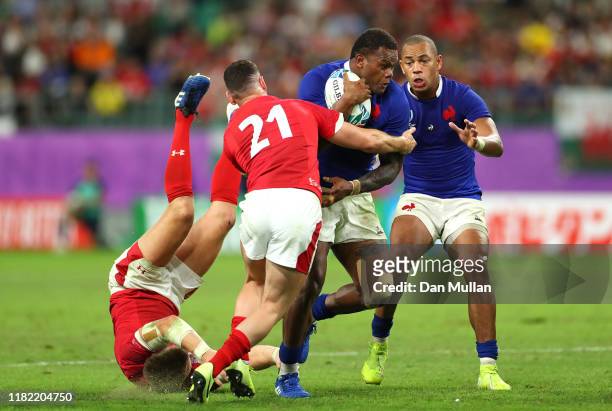 Virimi Vakatawa of France is tackled by Tomos Williams and Hadleigh Parkes of Wales during the Rugby World Cup 2019 Quarter Final match between Wales...