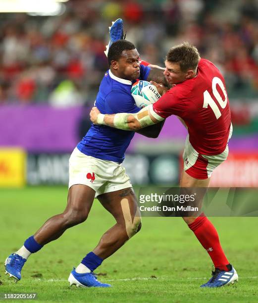 Virimi Vakatawa of France is tackled by Dan Biggar of Wales during the Rugby World Cup 2019 Quarter Final match between Wales and France at Oita...