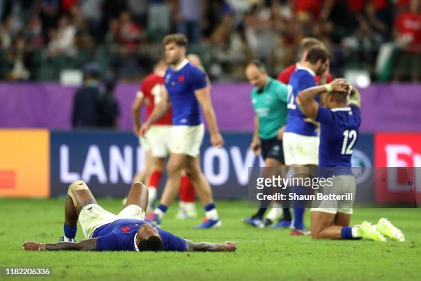 Virimi Vakatawa and Gael Fickou of France look dejected after defeat during the Rugby World Cup 2019 Quarter Final match between Wales and France at...
