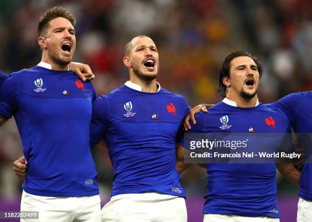 Bernard Le Roux, Wenceslas Lauret and Camille Chat sing the national anthem prior to the Rugby World Cup 2019 Quarter Final match between Wales and...
