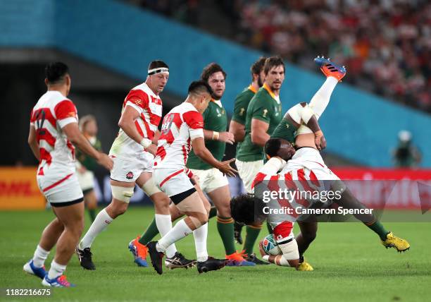 Keita Inagaki of Japan is spear tackled by Tendai Mtawarira of South Africa who is later given a yellow card during the Rugby World Cup 2019 Quarter...