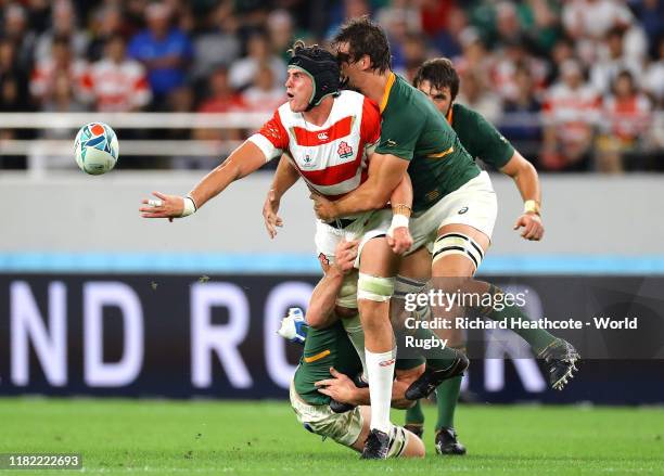 James Moore of Japan is tackled by Lodewyk De Jager and Pieter-Steph Du Toit of South Africa during the Rugby World Cup 2019 Quarter Final match...