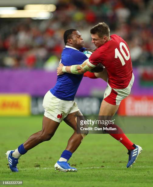 Virimi Vakatawa of France bumps off the tackle of Dan Biggar of Wales during the Rugby World Cup 2019 Quarter Final match between Wales and France at...
