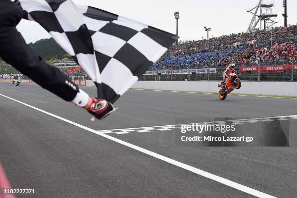 Marc Marquez of Spain and Repsol Honda Team cuts the finish lane and celebrates the victory at the end of the MotoGp race during the MotoGP of Japan...