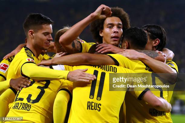 Marco Reus of Borussia Dortmund celebrates scoring his teams first goal of the game with team mates during the Bundesliga match between Borussia...