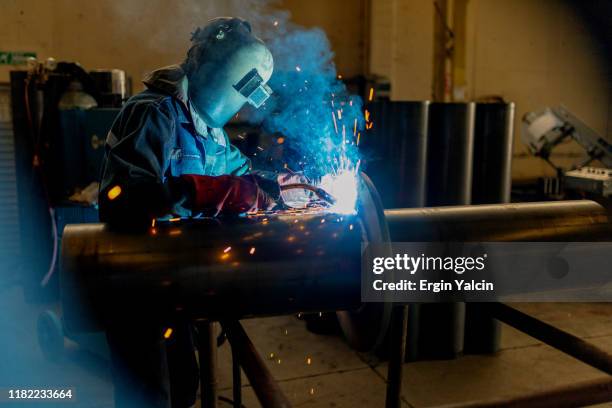 industrial worker welding on the pipe - welding stock pictures, royalty-free photos & images