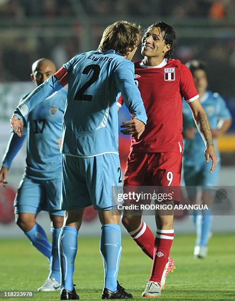 Peruvian forward Paolo Guerrero and Uruguayan defender Diego Lugano talk during their 2011 Copa America Group C first round football match, at the...