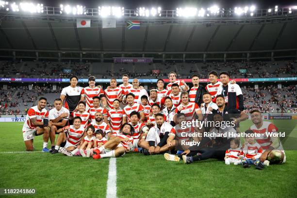 Members of the Japanese team pose for a photo on the pitch after the Rugby World Cup 2019 Quarter Final match between Japan and South Africa at the...