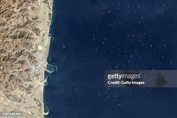 Oil tankers and bulk carriers moored along Fujairah offshore anchorage area on the Gulf of Oman, United Arab Emirates.