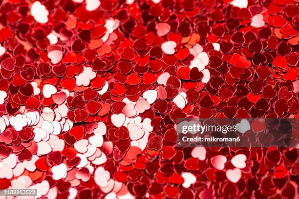 heart shape red confetti - heart month fotografías e imágenes de stock