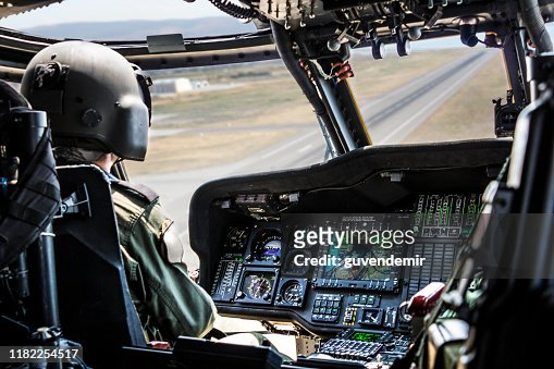 Army Helicopter Pilot riding military helicopter