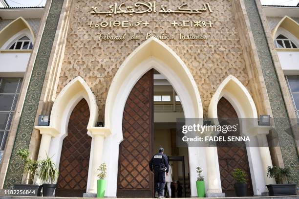 Member of the Moroccan security forces stands in front of the tribunal of Sale near the capital Rabat on November 14, 2019 during the trial of...