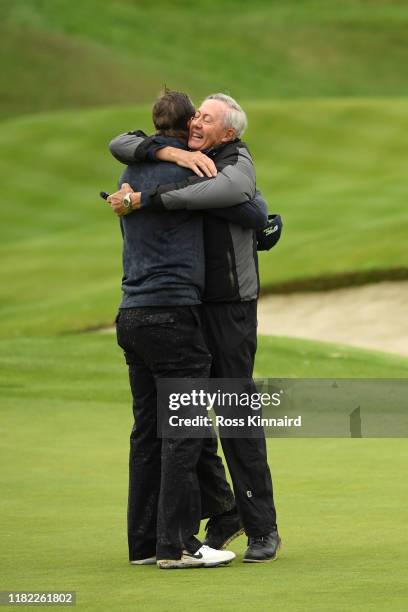 Nicolas Colsaerts of Belgium celebrates with his Father on the 18th green during Day 4 of the Open de France at Le Golf National on October 20, 2019...