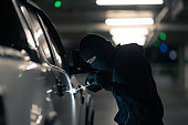 Robbers are robbing cars. Parked in the night parking