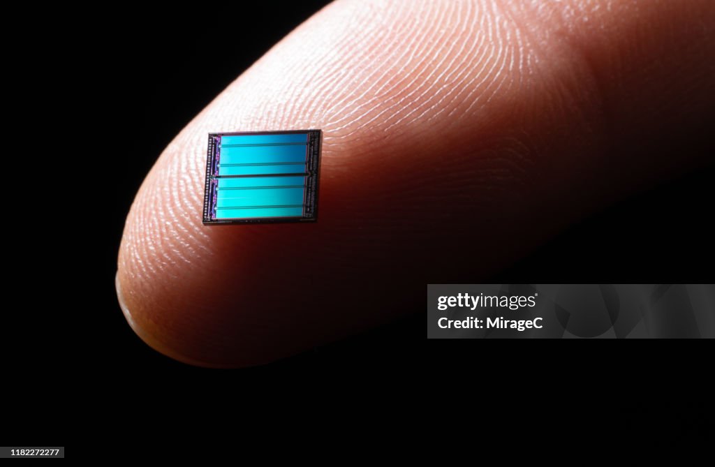 Pinpoint Computer Cell Blue Blue Computer Chip On Tip Of Index Finger Photo - Getty Images
