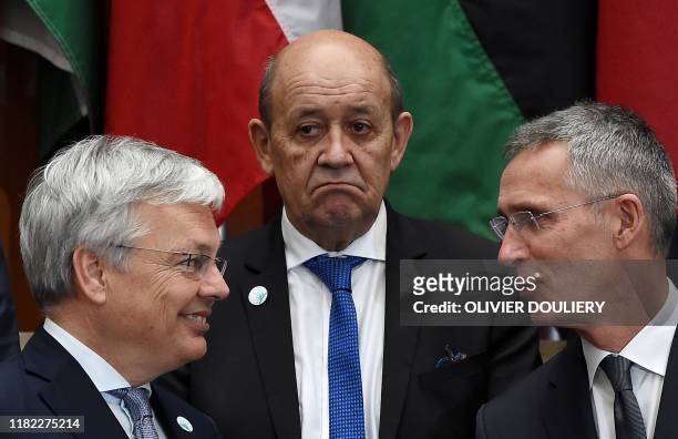 French Foreign Affairs Minister Jean-Yves Le Drian stands with Jens Stoltenberg, Secretary General of NATO and Belgian Foreign Minister Didier...
