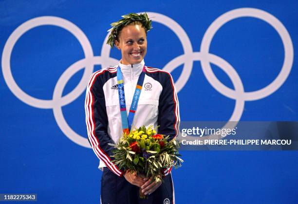 Amanda Beard poses on the podium after winning the women's 200m breaststroke gold medal, at the 2004 Olympic Games at the Olympic Aquatic Center in...