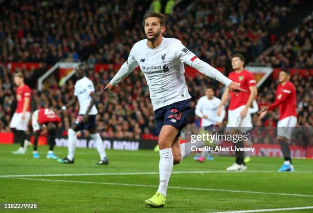 Adam Lallana of Liverpool celebrates after scoring his sides first goal during the Premier League match between Manchester United and Liverpool FC at...