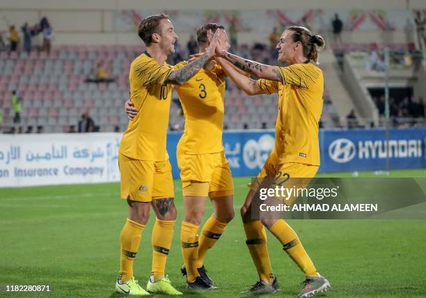 Australia's forward Adam Taggart celebrates with his teammates after scoring a goal during the Group B FIFA World Cup 2022 and the 2023 AFC Asian...