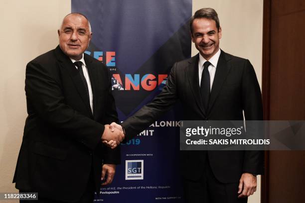 Greek Prime Minister Kyriakos Mitsotakis welcomes as he shakes hands with his counterpart from ?ulgaria Boyko Borisov , during the economic summit of...