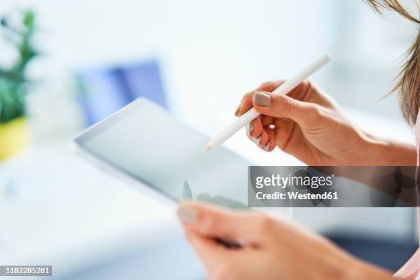close up of woman using pen and tablet in office - digitizer imagens e fotografias de stock
