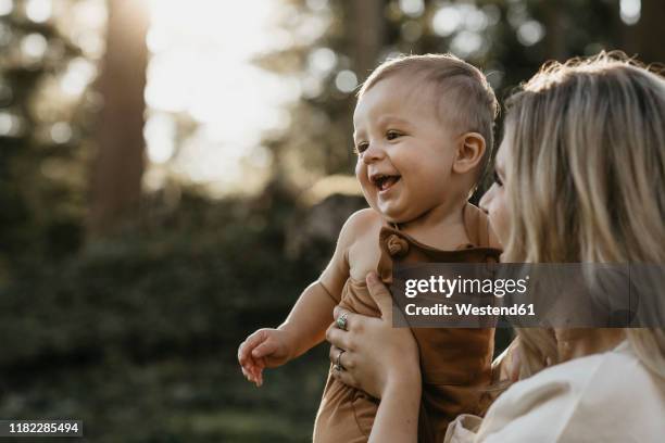 mother holding her little son on a hiking trip, schwaegalp, nesslau, switzerland - mothers babies stockfoto's en -beelden