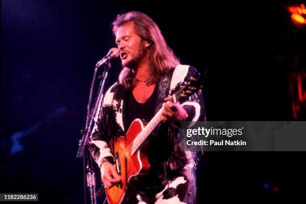 American Country musician Travis Tritt plays guitar as he performs onstage at the Star Plaza Theater, Merrillville, Indiana, August 15, 1995.