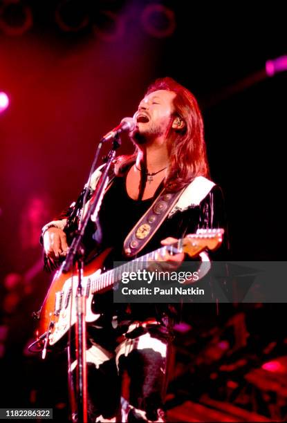 American Country musician Travis Tritt plays guitar as he performs onstage at the Star Plaza Theater, Merrillville, Indiana, August 15, 1995.