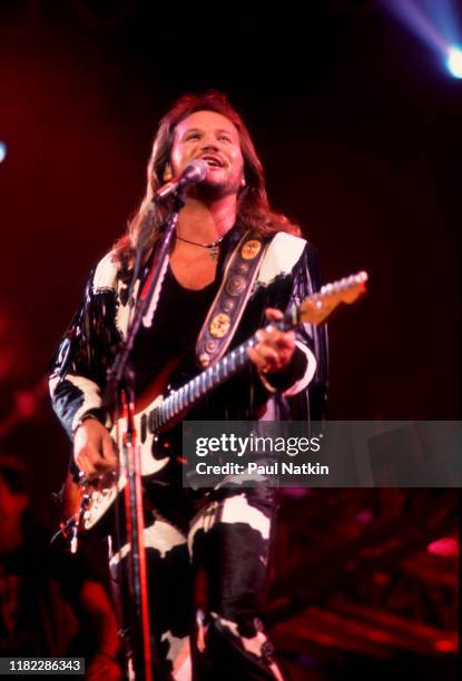 American Country musician Travis Tritt plays guitar as he performs onstage at the Star Plaza Theater, Merrillville, Indiana, August 15, 1995.