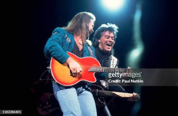 American Country musicians Travis Tritt and Marty Stuart both play guitars as they perform onstage at the Star Plaza Theater, Merillville, Indiana,...