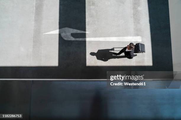 top view of businessman with baggage on the go - airport above stock-fotos und bilder