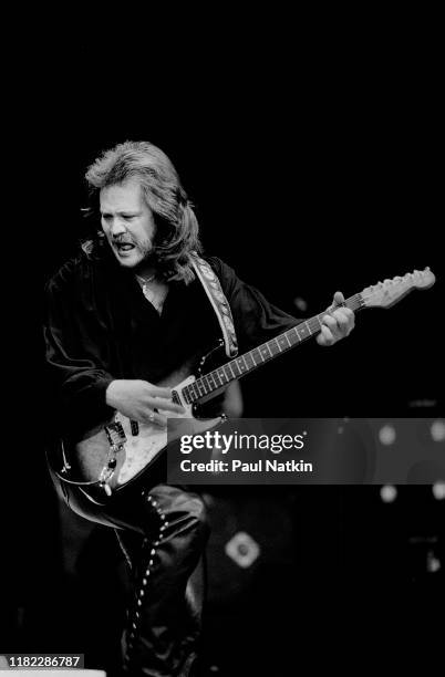 American Country musician Travis Tritt plays guitar as he performs onstage at the Poplar Creek Music Theater, Hoffman Estates, Illinois, September 5,...