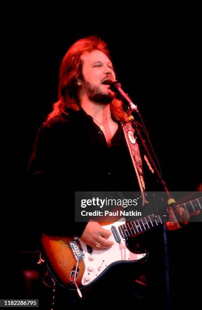 American Country musician Travis Tritt plays guitar as he performs onstage at the Poplar Creek Music Theater, Hoffman Estates, Illinois, September 5,...