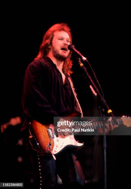 American Country musician Travis Tritt plays guitar as he performs onstage at the Poplar Creek Music Theater, Hoffman Estates, Illinois, September 5,...