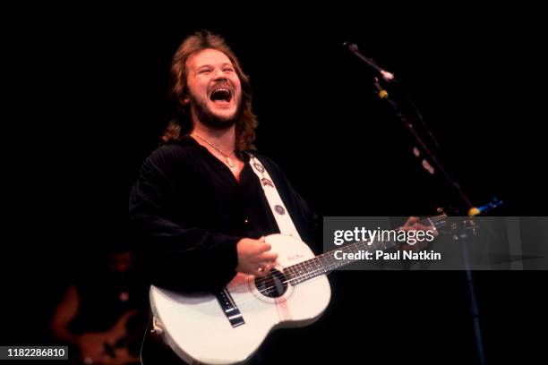 American Country musician Travis Tritt plays guitar as he performs onstage at the Poplar Creek Music Theater, Hoffman Estates, Illinois, September 5,...