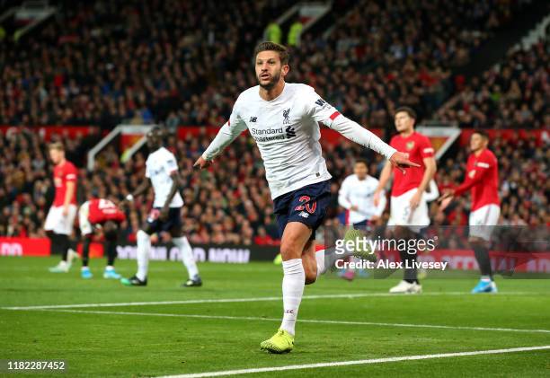 Adam Lallana of Liverpool celebrates after scoring his sides first goal during the Premier League match between Manchester United and Liverpool FC at...
