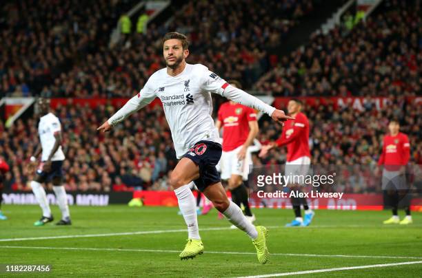 Adam Lallana of Liverpool celebrates after scoring his sides first goal during the Premier League match between Manchester United and Liverpool FC at...