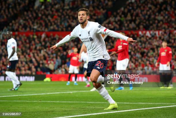 Adam Lallana of Liverpool celebrates after scoring his sides first goal during the Premier League match between Manchester United and Liverpool FC at...
