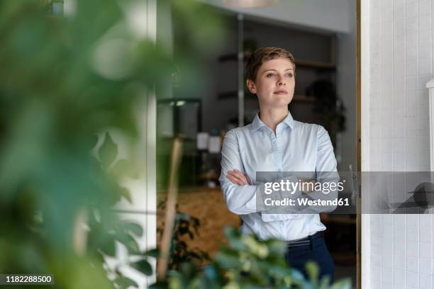 woman in a cafe looking sideways - business woman blouse stock-fotos und bilder