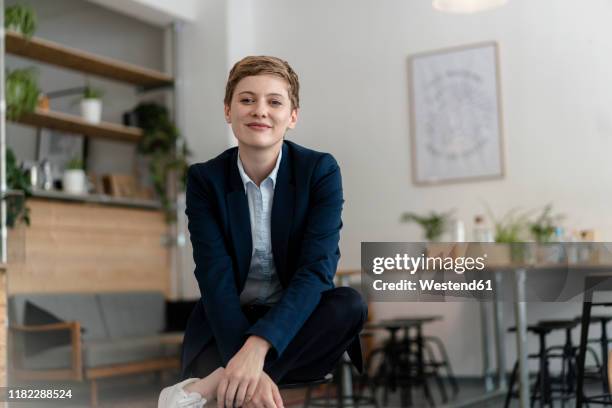 portrait of confident businesswoman sitting in a cafe - blazer bildbanksfoton och bilder