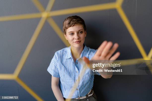 woman touching a structure - erklären stock-fotos und bilder