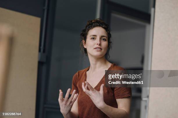 portrait of gesturing young woman - explaining stock pictures, royalty-free photos & images