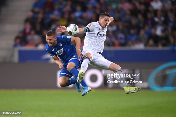 Bastian Oczipka of FC Schalke 04 battles for possession with Pavel Kaderabek of TSG 1899 Hoffenheim during the Bundesliga match between TSG 1899...