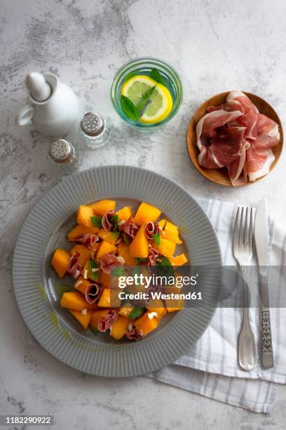 directly above shot of melon salad served with drink on table - jamón de parma fotografías e imágenes de stock