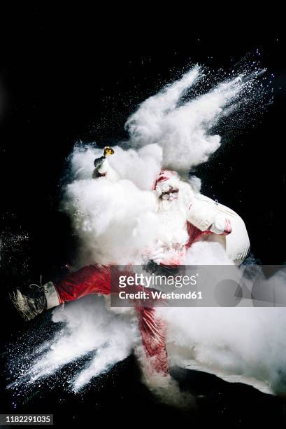 santa claus with exploding snow bomb against black background - crazy white hair stock pictures, royalty-free photos & images