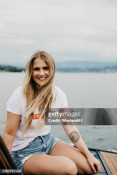 portrait of happy young woman on a boat trip on a lake - lake zurich stock pictures, royalty-free photos & images