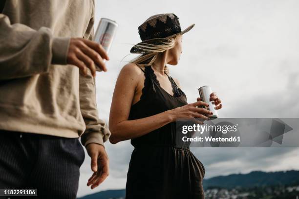 young couple having a drink outdoors - blank can stockfoto's en -beelden